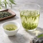 Brewed Mingqian Xinyang Maojian Tea with clear liquor