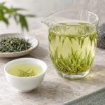 Brewed Pre-Guyu Xinyang Maojian Tea with clear liquor